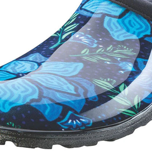 A single slip-on gardening clog shoe by St. Loggers, featuring a glossy blue and black floral pattern with green leaves on a white background.