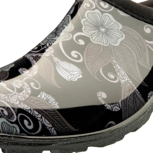 A single slip-on clog-style gardening shoe by Stuggs, featuring a glossy black and gray floral pattern with a gray sole and dark gray collar.