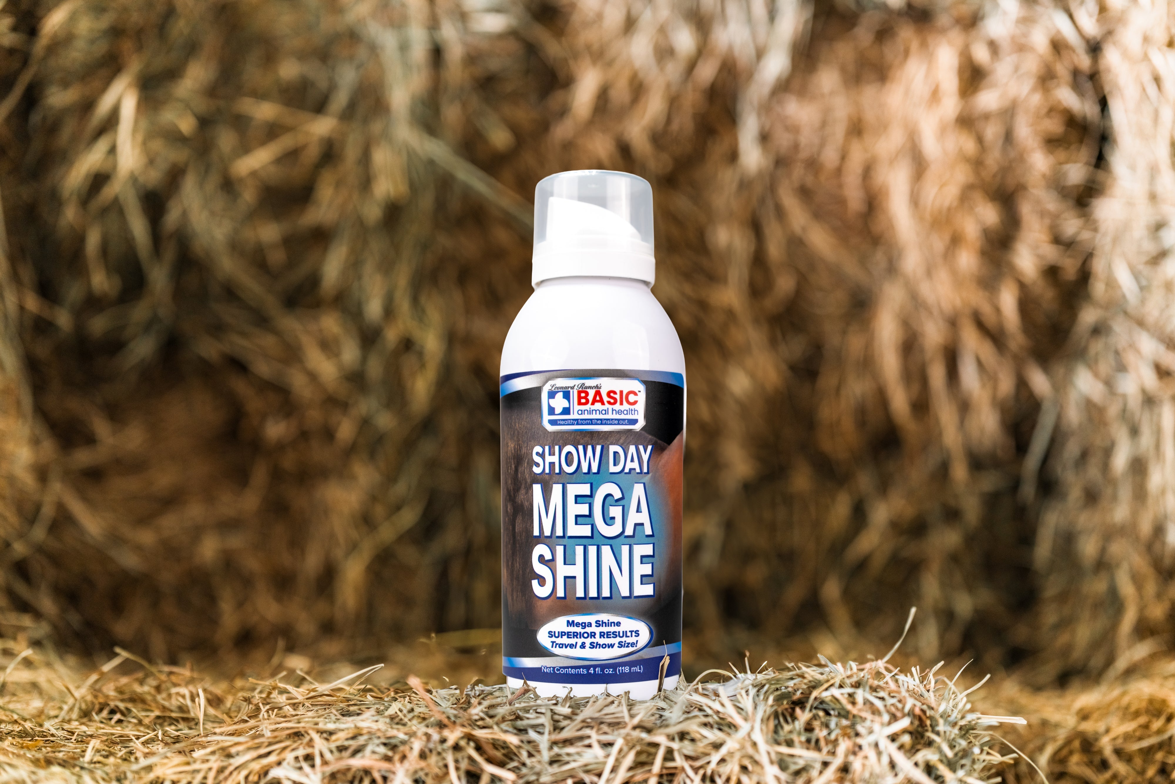 Mega Shine 4 oz grooming product for animals, featuring a shiny coat in a barn setting by Basic Animal Health.