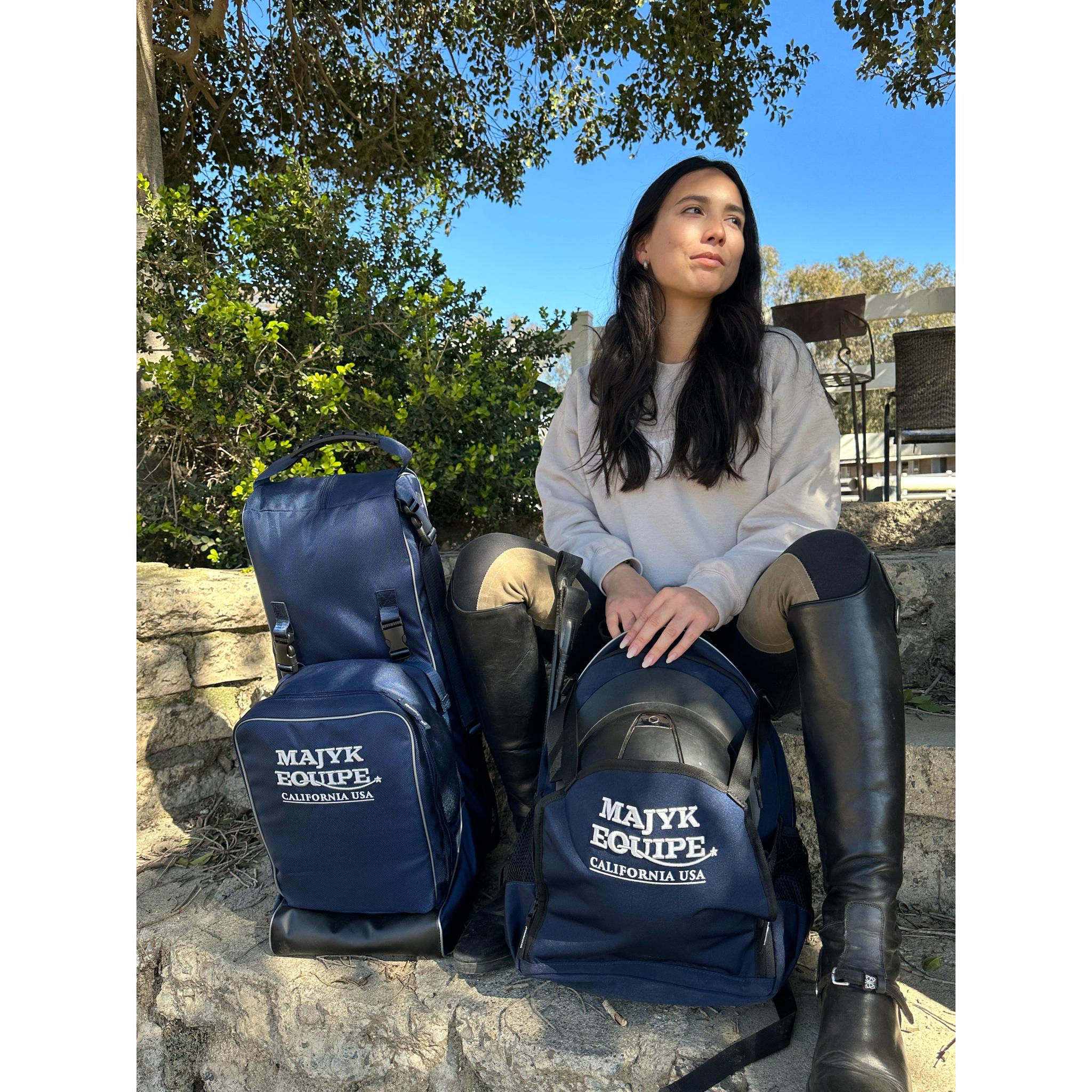 Majyk Equipe Show/Barn Bag featuring a spacious hat compartment and durable design, shown from a distance.