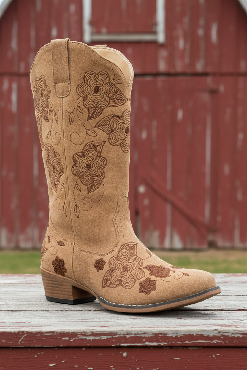 Tan cowboy boot with floral embroidery on a white background